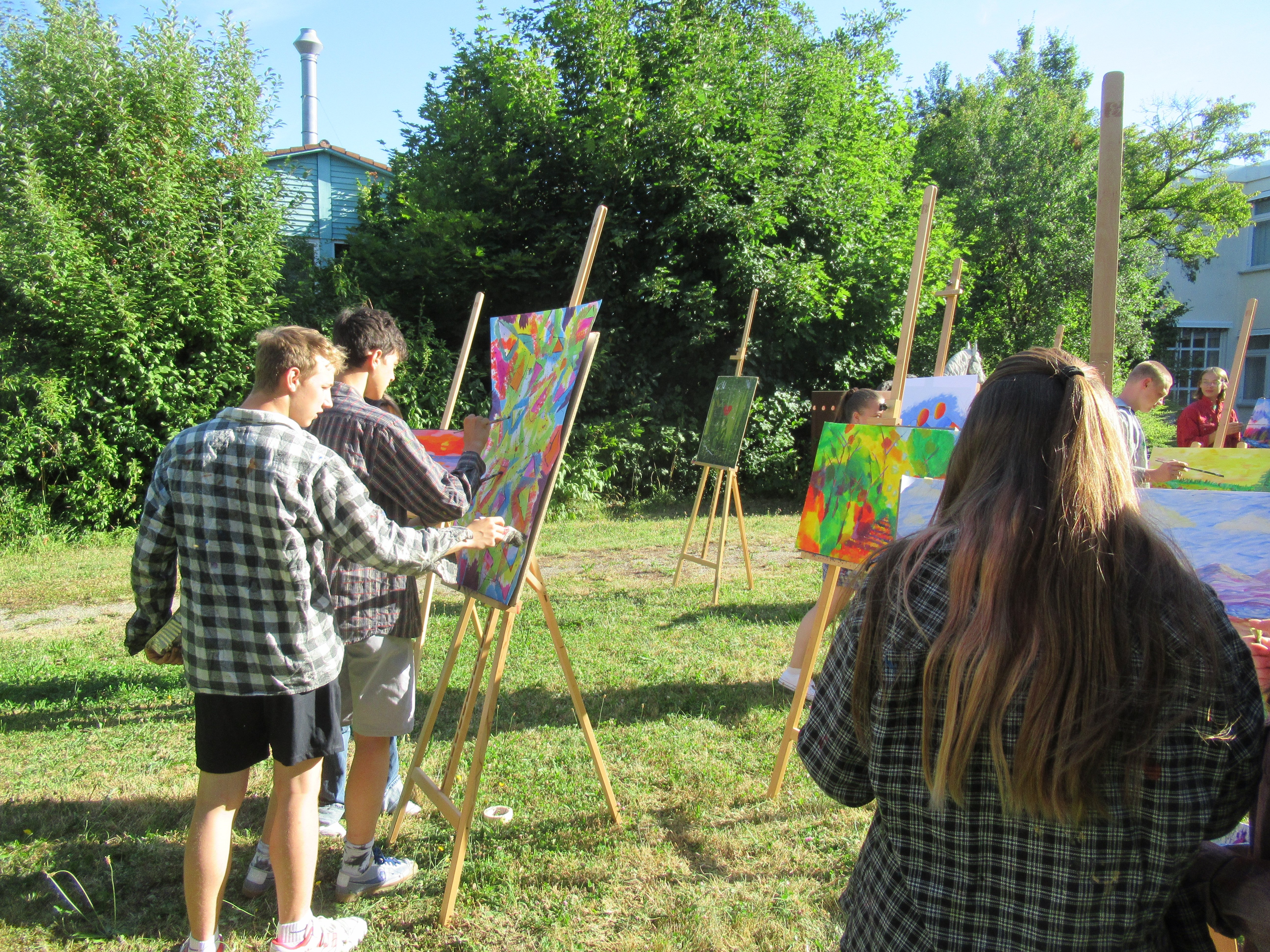 Schüler malen an einer Staffelei
